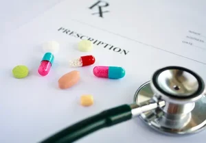 Pills and stethoscope on a prescription