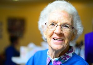 image of a woman smiling and happy to learn more about stretching