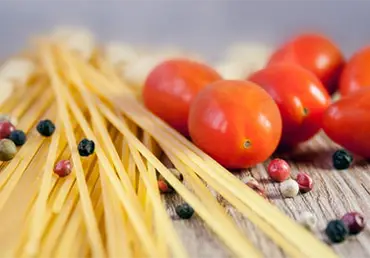 Image of pasta noodles and tomatoes.
