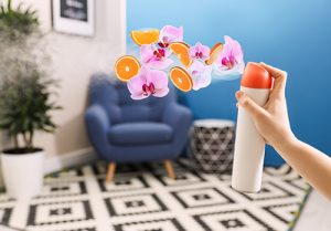 An air freshener is sprayed in a room.