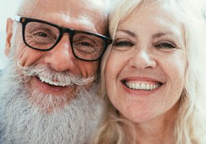 Man and woman smiling.