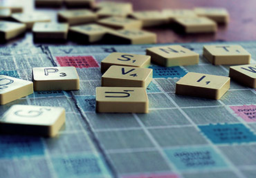 Lettered tiles are arranged in a random way on a game board.