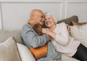 Elderly parents sitting in their home.