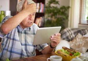 Senior man surprised by a scam