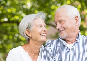 Senior couple smiling at each other.