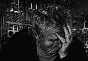 Man with hand on face depressed
