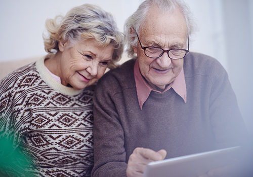 Older couple looking at screen.