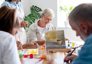 Seniors learning to paint at community center