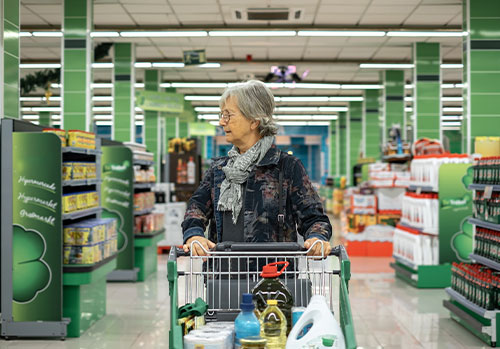 Senior woman doing groceries with a discount