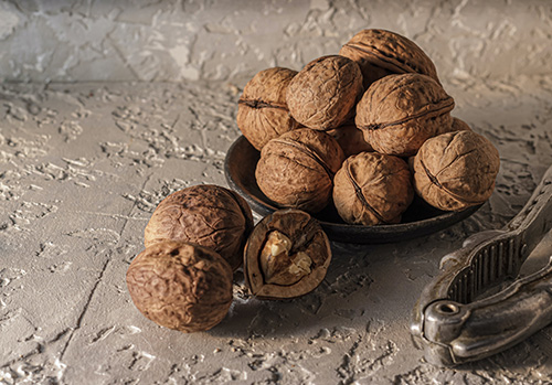 Walnuts are arranged decoratively in bowl.
