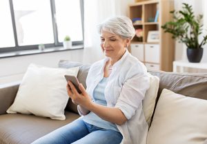 A senior woman looks at cellphone.