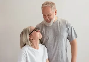 An elderly couple looks at each other with love.