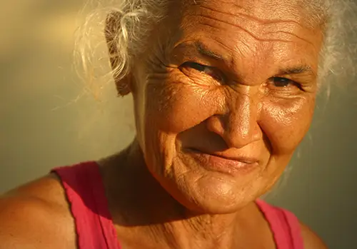 An older lady smiles at the camera.