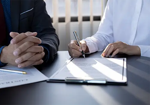 agent and customer going over insurance contract in an office setting