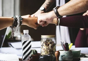 a team from a small business fist bumping