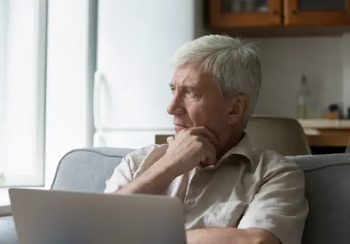 medicare faqs for seniors senior thinking looking away pondering hand on chin large image