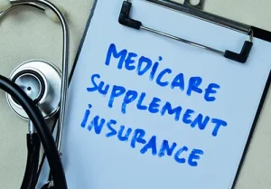 Clipboard with stethoscope on top, text reads "Medicare Supplement Insurance"