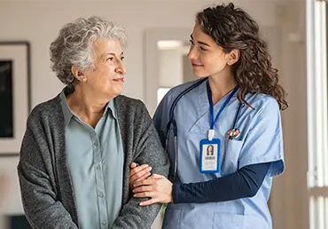 Elderly woman receives support from nurse
